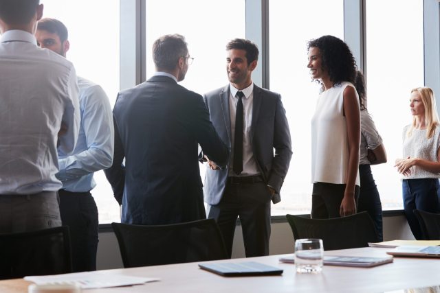 Businesspeople,Shaking,Hands,Before,Meeting,In,Boardroom